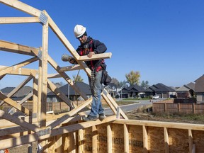 Jeff Apthorp, owner of Forest City Framing, nails in a spacer in a home being built in October 2020 in a new subdivision in Strathroy-Caradoc. Middlesex County has hired a consultant to review its housing stock to help it determine its housing needs. (Mike Hensen/The London Free Press)
