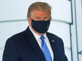 U.S. President Trump walks to the Marine One helicopter wearing a protective face mask as he departs the White House to fly to Walter Reed National Military Medical Center, where it was announced he will work for at least several days after testing positive for the coronavirus disease (COVID-19), on the South Lawn of the White House in Washington, U.S., October 2, 2020. REUTERS/Leah Millis/File Photo