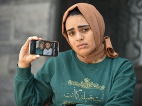 Alia Youssef sits on the porch at her Lasalle, Ont., home just outside of Windsor, on Wednesday, Oct. 7, 2020 wearing the same clothes she wore the last time she saw Mohamed, her American fiancee who is stuck in Michigan. Alia has not seen her fiancee since the border between Canada and the United States closed in March.