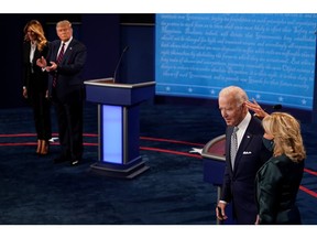 U.S. first lady Melania Trump stands with President Donald Trump, and former vice-president Joe Biden stands with wife Jill Biden, during the first presidential debate at Case Western University and Cleveland Clinic. Sept. 29.