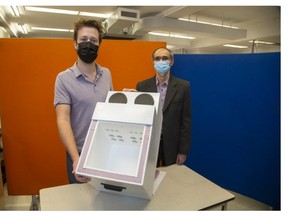 Steven Jevnikar, a research associate with the Lawson Health Research Institute, and Kamran Siddiqui, an engineering professor at Western University, show a prototype of a device they've designed to better transport organs and vaccines. Derek Ruttan/The London Free Press