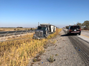 A tractor trailer came to a stop in the median of Highway 401 near Mull Road in Chatham-Kent after blowing a tire at about 1:20 p.m. Sunday, Chatham-Kent OPP said. A cable barrier prevented the truck from crossing over into oncoming lanes. (OPP photo)