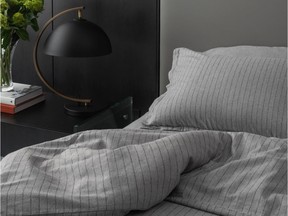 Neutral deep grey sheets complement many existing bedding accessory colours in comforters, pillows and throws. Cozy Flannel Sheet Set, grey stripes, from $258, Envello.com