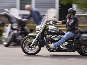 A motorcyclist rides through Port Dover, Ontario during the traditional Friday the 13th Gathering of bikers in the small fishing town on the Lake Erie shore. Brian Thompson/Brantford Expositor/Postmedia Network