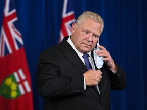 Ontario Premier Doug Ford arrives for a press conference during the COVID-19 pandemic in Toronto, Friday, November 20, 2020. Ontario is moving the COVID-19 hot spots of Toronto and Peel Region into lockdown starting Monday. (THE CANADIAN PRESS/Nathan Denette)
