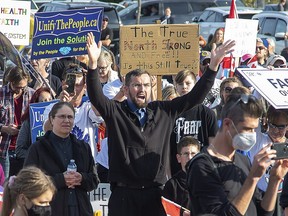 A crowd of 2,000 listen to speakers at the East Elgin Community Centre during a protest against public health measures in Aylmer on Nov. 7, 2020. (Derek Ruttan/The London Free Press)