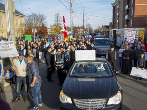 Two-thousand people marched through Aylmer's downtown during a Saturday protest against public-health measures intended to stop the spread of the COVID-19 virus. Derek Ruttan/The London Free Press/Postmedia Network ORG XMIT: POS2011071732272790