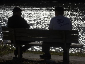 Larry Kilpatrick of London (left) and Butch Heslop of Thorndale enjoy a gorgeous day beside the Thames River at Lion's Park in St. Marys this week. The pair often travel to St. Marys to drink coffee and chat. Derek Ruttan/The London Free Press/Postmedia Network