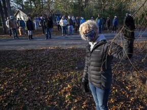Romayne Smith-Fullerton and her Port Franks neighbours are urging council to do something about the town's gypsy moth infestation. She is standing with a pine tree the group says was killed by gypsy moth caterpillars. (Derek Ruttan/The London Free Press)