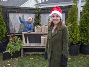 Chair of the Bayfield and Area Chamber of Commerce  Leanne Kavanagh  and Bayfield's councillor on the Municipality of Bluewater Council  pose at the Christmas themed "social distance selfie station" set up in front of the library in Bayfield. (Derek Ruttan/The London Free Press)
