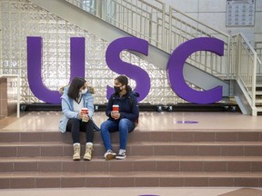 First-year Western University students Sogol Noormandi (left) and Maha Khawaja enjoy coffee in the University Community Centre, home of the University Student Council (USC) in London in this November 2020 photo. (Derek Ruttan/The London Free Press)