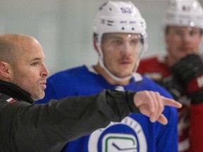 Bo Horvat of the Vancouver Canucks, middle, and Lawson Crouse of the Arizona Coyotes, right, listen to hockey skills coach Dwayne Blais during a training session at the Western Fair Sports Centre in London on Thursday. London has become a magnet for pros and juniors looking to improve their skills and keep them sharp. (Derek Ruttan/The London Free Press)