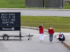 People gather outside of the Western COVID-19 Testing Centre at Western University in November. The university is dealing with a COVID-19 outbreak at one of its student residences. (Derek Ruttan/The London Free Press)