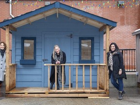 Lori Long, Ange Rivard and Martha Leach show one of 15 vendor huts set up outside 100 Kellogg Lane for a Christmas market in November 2020. The venue announced Monday it's holding a Spring Market on three weekends next month. (Derek Ruttan/The London Free Press)