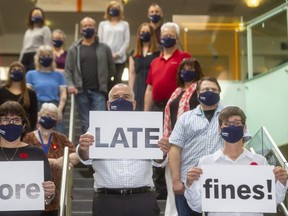 One less reason to skip the library, they've gotten rid of those darn late book fines. From Left to right with signs are Kate Scarfe, Leonor DaCosta, Michael Ciccone, the CEO and Sherry Graham. (Mike Hensen/The London Free Press)