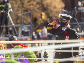 Capt. Sean Batte of the Royal Canadian Navy salutes after placing a wreath on behalf of the Canadian Armed Forces during a restrained Remembrance Day ceremony in London. (Mike Hensen/The London Free Press)