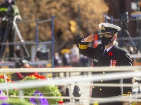 Capt. Sean Batte of the Royal Canadian Navy salutes after placing a wreath on behalf of the Canadian Armed Forces during a restrained Remembrance Day ceremony in London on Wednesday. (Mike Hensen/The London Free Press)