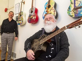 Clark Bryan, executive director of Aeolian Hall, has been very good, so Santa, in the form of guitar collector and philanthropist Dave Southen, dropped off his gifts a little early. Bryan says Southen's gift of guitars valued at $50,000, and a  matching cash gift of $50,000 couldn't have come at a better time during s year of no concerts due to COVID-19. Southen is holding a resonating guitar signed by American blues singer/guitarist Johnny Winter in front of a collection of previously donated painted guitars. (Mike Hensen/The London Free Press)