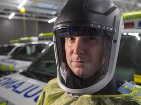 Jay Loosley of the Middlesex-London Paramedic Service wears a new respirator that will be used by a specialized team trained and equipped to transport people with highly contagious illnesses, such as COVID-19. (Mike Hensen/The London Free Press)