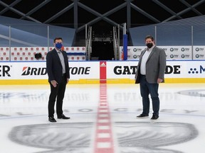 Oilers Entertainment Group senior vice-president of communications Tim Shipton, left, and senior vice-president of operations Stu Ballantyne stand at centre ice in the middle of the Hub City bubble at Rogers Place, where the world junior hockey championship is scheduled to begin Christmas Day.