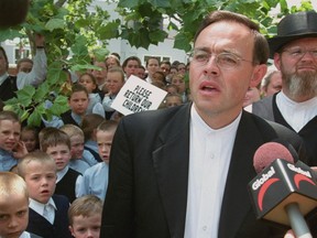 Reverand Henry Hildebrandt of the Aylmer Church of God reads a statement  outside court in St. Thomas Monday, July 9, 2001.