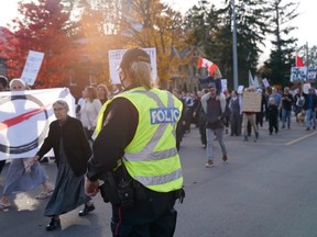 Anti-lockdown protesters march through Aylmer, essentially shutting down traffic. (Max Martin/The London Free Press)