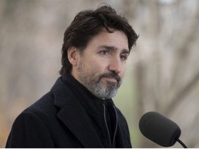 Prime Minister Justin Trudeau pauses after responding to a question about the holidays during a news conference outside Rideau Cottage in Ottawa, Friday, Nov. 20, 2020.