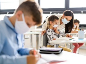 Group of children with face mask back at school after covid-19 quarantine and lockdown.