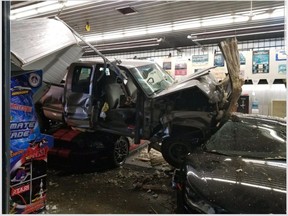 A stolen pickup truck crashed through the garage bay doors of Midtown Motors on Bell Street in Ingersoll early Thursday, damaging several classic vehicles. (OPP photo)