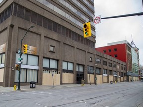 Wooden boards cover all of the ground floor windows of buildings on the west side of Richmond Street between King Street and Dundas Street in London, (Derek Ruttan/The London Free Press)