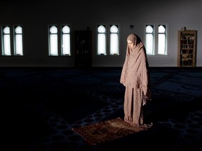 Hassna Moussa prays at the London Muslim Mosque on Wednesday April 22, 2020. (Derek Ruttan/The London Free Press)