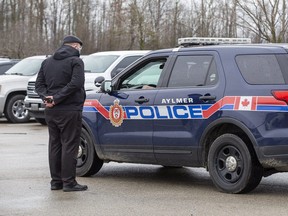 Police speak to Church of God official Herbert Hildebrandt in Aylmer in this April 2020 file photo.  (Derek Ruttan/The London Free Press)