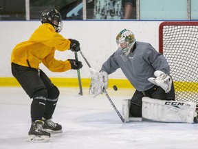 Noah Cameron of the London Jr. Knights U16 team shoots on Charlie Robertson during a   practice Wednesday at Western Fair Sports Centre. The Jr. Knights are gearing up for their first action this season against an opponent, but the game scheduled for Monday against the Elgin-Middlesex Chiefs will be cancelled if Middlesex-London moves into the red-control zone in Ontario's COVID-19 response framework. Derek Ruttan/The London Free Press/Postmedia Network