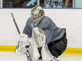 London Junior Knights AAA U-18 goalie Charlie Robertson makes a save while practicing with the team at Western Fair Sports Centre in London. (Derek Ruttan/The London Free Press)