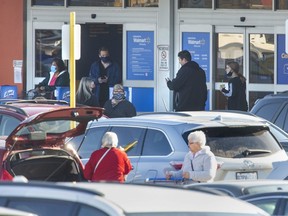 Shoppers enter and exit Walmart at White Oaks Mall in London, Ont. on Thursday December 10, 2020. (Derek Ruttan/The London Free Press)