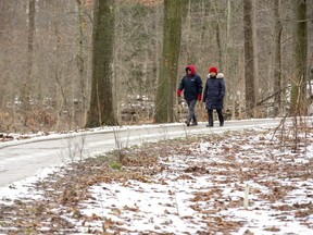 Miguel and Gladys Rivera of St. Thomas take a stroll through the woods at Pinafore Park in St. Thomas on Monday. "It's nice to get exercise and see nature," said Gladys. (Derek Ruttan/The London Free Press)