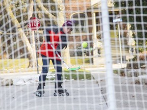 Eight-year-old Chase Sayer takes shots on net outside his home in Dresden. Normally, Chase is the one stopping the shots as a goalie with the Dresden Junior Kings but the season is on hold amid Ontario's provincewide lockdown. Derek Ruttan/The London Free Press/Postmedia Network ORG XMIT: POS2012291329112596