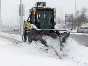 Tim O'Neill of Parkhill plows the sidewalk on Highbury Avenue in London, Ont. after the first real snowfall of the year. O'Neill says it was "sloppy and a bit slippery," as he moved the wet heavy snow. (Mike Hensen/The London Free Press)