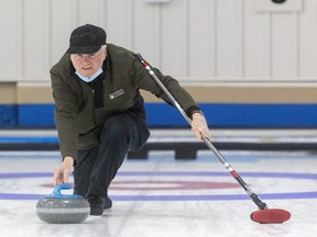 Steve Bowden throws a rock during a pickup match at the London Curling Club on Wednesday. (Mike Hensen/The London Free Press)