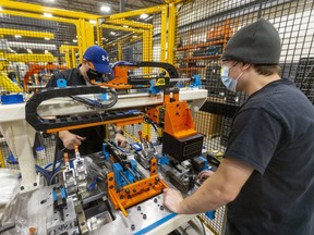 Steve Cook, left, and Jack Annett of Armo Tools on Admiral Drive build a testing rig for a local automobile manufacturer that precisely measures extruded aluminum stock, to make sure the dimensions are perfect before the piece is moved to the next step of computer-aided design. Armo Tools has been rigorous in adhering to COVID-19 safety precautions to keep its workers healthy and to be able to finish contracts on time. (Mike Hensen/The London Free Press)