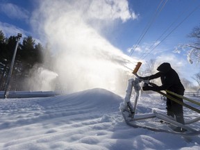Shaun Bonnallie, the outside operations manager at Boler Mountain checks one of their air-water guns that was making snow on the bunny hill in London. (Mike Hensen/The London Free Press)