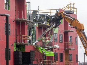 A large excavator from Toronto-based Priestly Demolition starts demolishing the building at 555 Teeple Terrace in London, one day after the under-construction apartment building partly collapsed. Two workers were killed. Photograph taken on Saturday December 12, 2020. Mike Hensen/The London Free Press