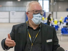Neil Johnson the Chief Operating Officer for LHSC walks the media through their COVID-19 vaccination centre they have set up at the Western Fair Agriplex in London, Ont. (Mike Hensen/The London Free Press)