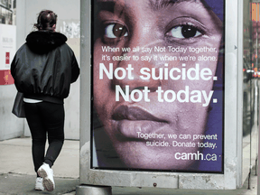 A pedestrian walks past a mental health advertisement during the COVID-19 pandemic. Canada invests just 7.2 per cent of $219 billion in total health spending on mental health.