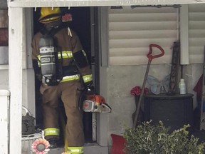 A St. Thomas firefighter enters a home on Park Avenue where a fire started at 1:45 p.m. Thursday. No one was injured and firefighters were able to rescue the family's dogs. Damage is estimated at $200,000. (St. Thomas fire department)