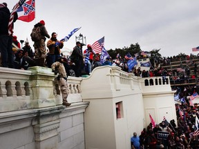 Thousands of Donald Trump supporters storm the United States Capitol building following a "Stop the Steal" rally on January 06, 2021 in Washington, DC. The protesters stormed the historic building, breaking windows and clashing with police. Trump supporters had gathered in the nation's capital today to protest the ratification of President-elect Joe Biden's Electoral College victory over President Trump in the 2020 election. (Photo by Spencer Platt/Getty Images)