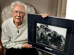 82-year-old George Nutkins holds a photo of the train from which he was thrown in the May 1956 train wreck that he survived but with 21 broken bones and after two years of hospitalization. This photo was taken in 2006, 50 years later. (LFP Archives)