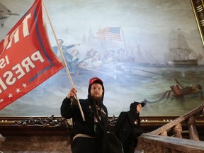 A protester holds a Trump flag inside the US Capitol Building near the Senate Chamber on January 06, 2021 in Washington, DC.