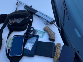 London police seized a sawed-off rifle, ammunition, brass knuckles, small amounts of suspected crystal methamphetamine and suspected fentanyl and cellphones during an arrest Thursday. (Police supplied photo)