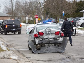 Police are investigating an alleged drive-by shooting on Millbank Drive near Bexhill Drive in London on New Year's Day. During the incident one vehicle car reversed into a tree, causing the damage seen here. (Derek Ruttan/The London Free Press)